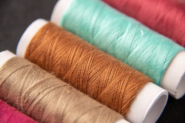 front-view-colorful-threads-dark-surface